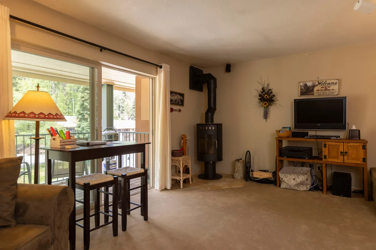 A warm dining area with a small table set for two, cozy chairs, and a wood-burning stove in the background, offering the perfect setting for romantic dinners or relaxed breakfasts.